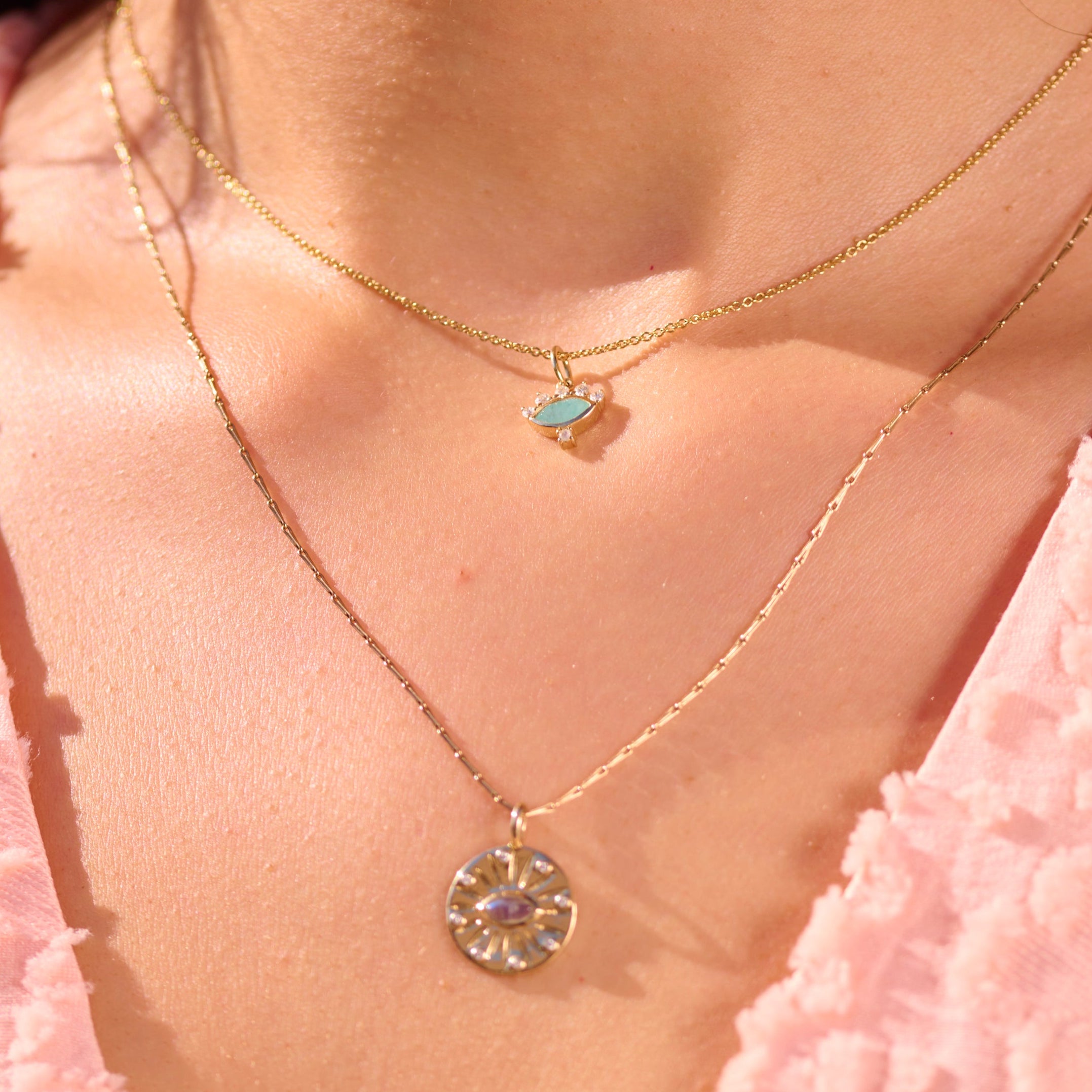 close up of the Amazonite, Diamond & Moonstone Eye Pendant 9k Gold layered with labradorite coin pendant in recycled solid gold