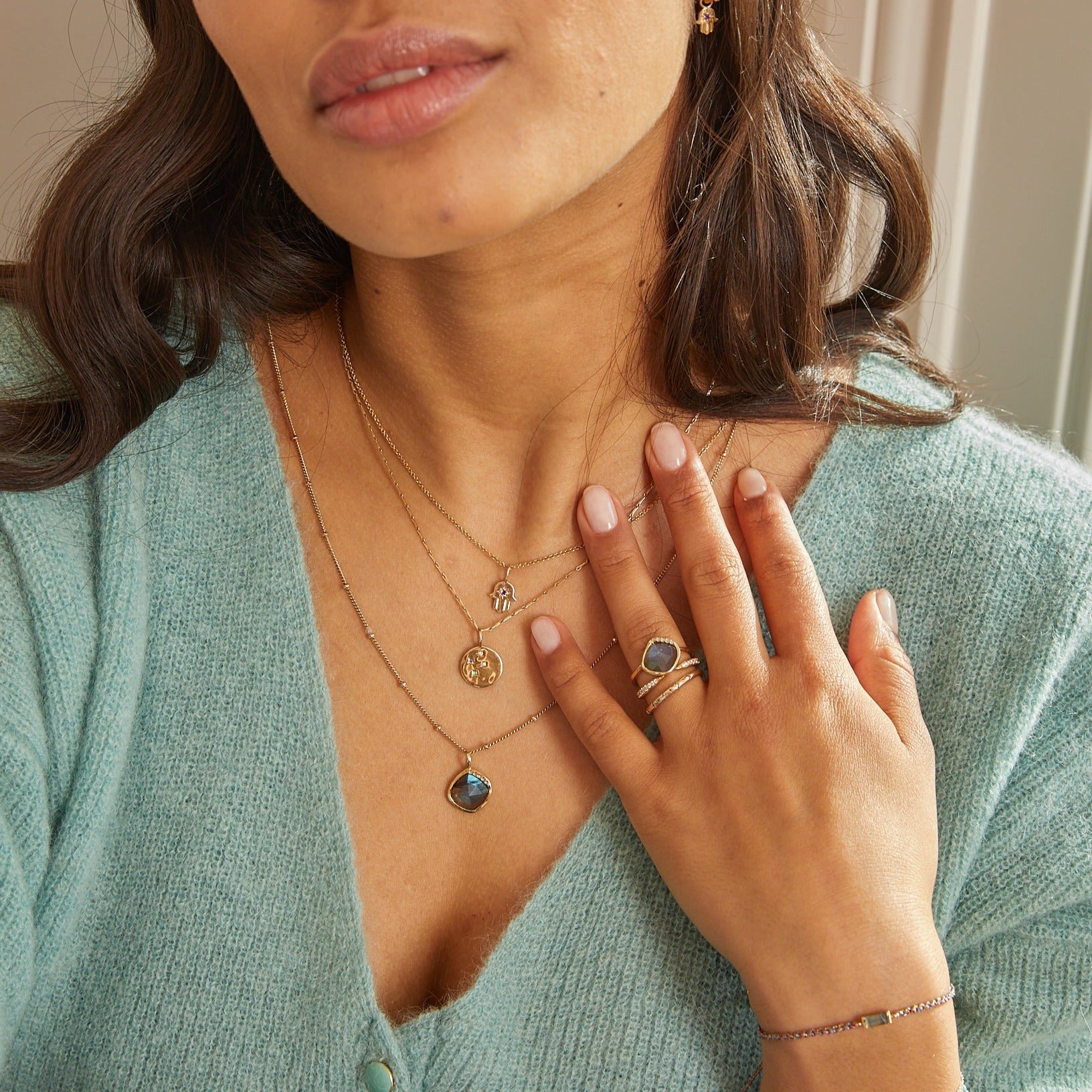 model wearing labradorite and solid gold pieces including the Grecian Labradorite Stone Pendant 9k Gold