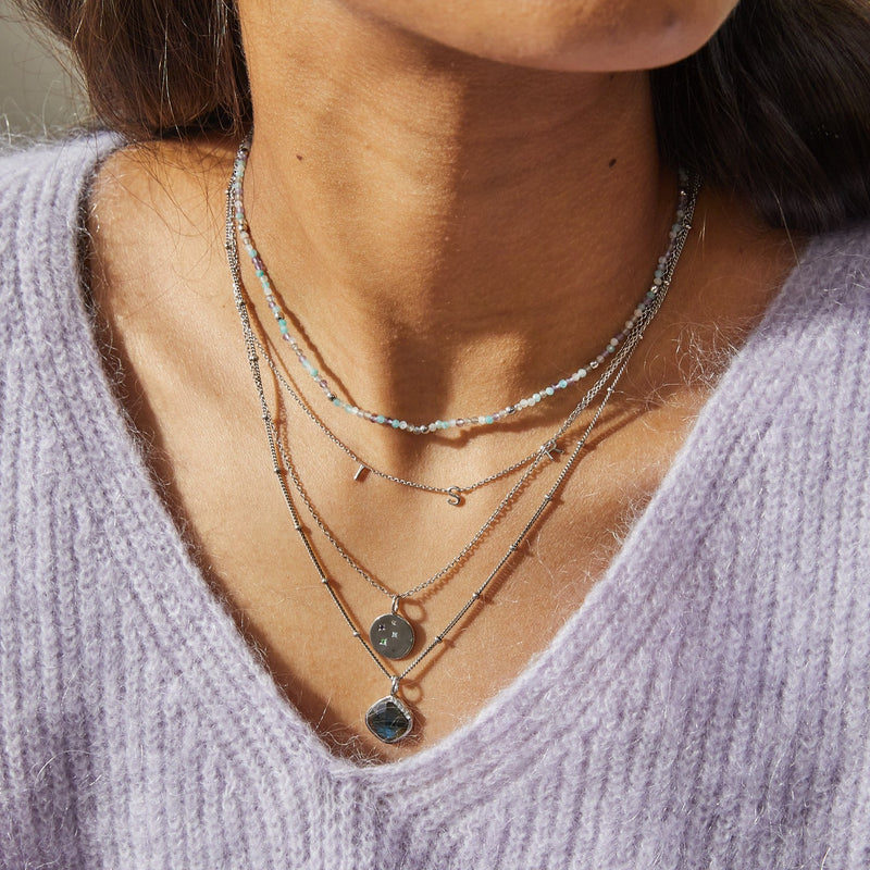 model  layering silver necklaces including the Grecian Labradorite Stone Pendant Sterling Silver