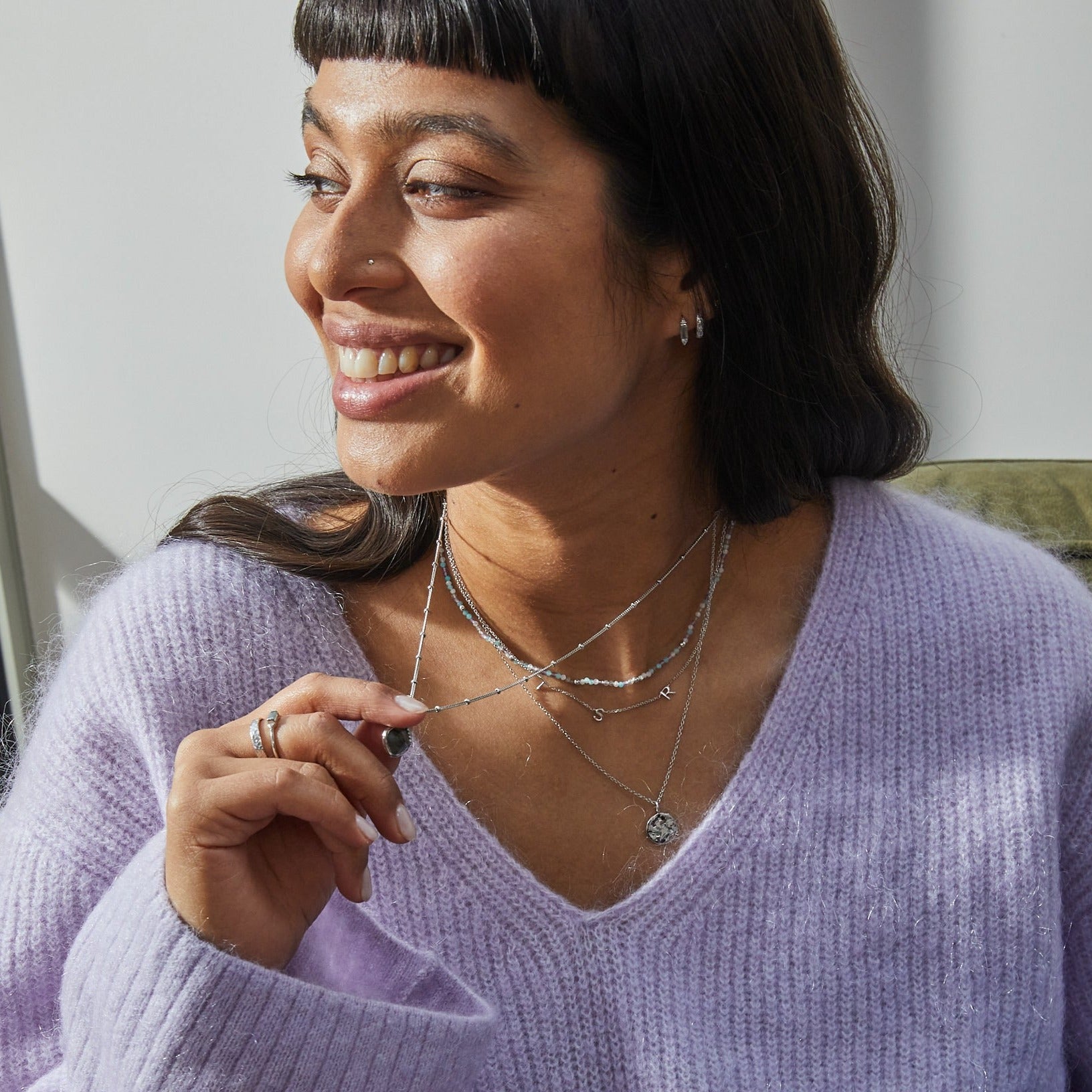 Model wearing sterling silver jewellery including the Labradorite & White sapphire Huggie Hoop Earring Sterling Silver