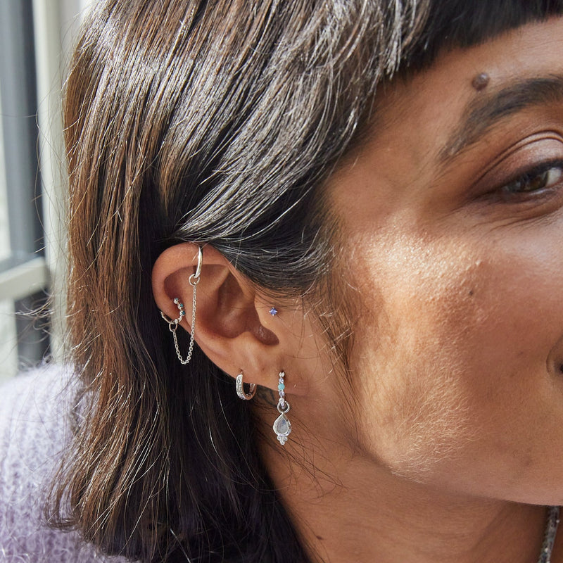 model wearing silver earring stack including the Amazonite, Tanzanite & Moonstone Huggie Hoop Earring Sterling Silver