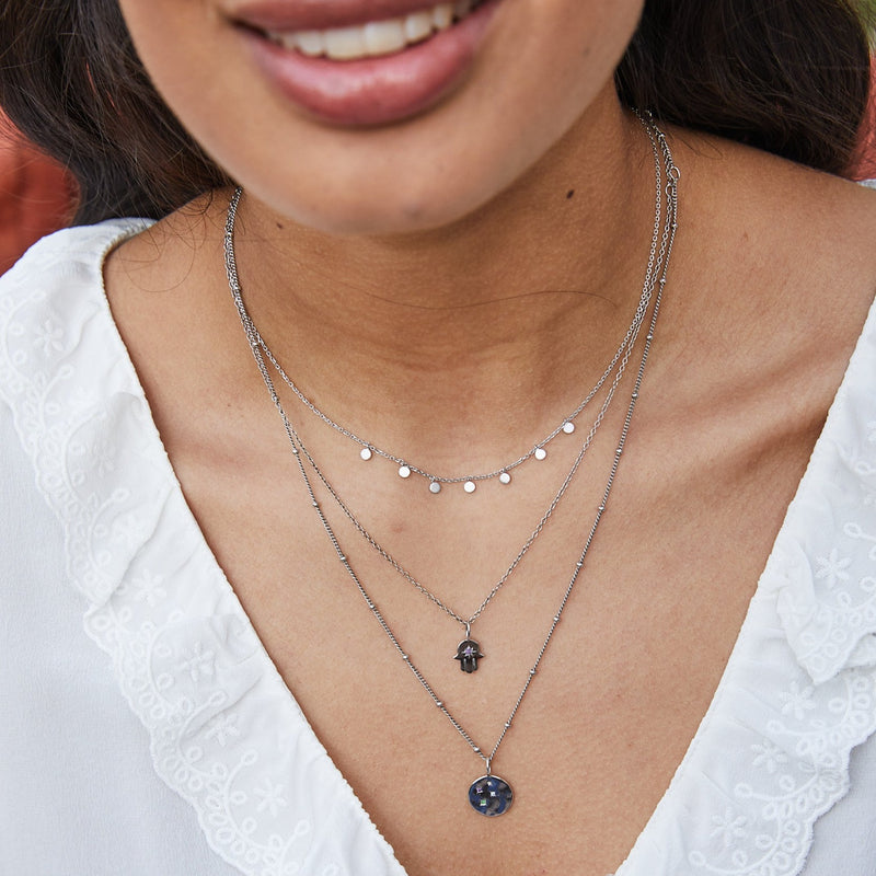 model wearing mini coin, hand of fatima and the Mini Coin Necklace Sterling Silver