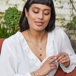 model wearing silver pieces including the Mini Coin Necklace Sterling Silver