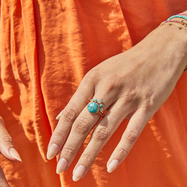 model wearing solid gold turquoise copper and carnelian ring along with the Semi-Precious Stone Hugging Ring 9k Gold