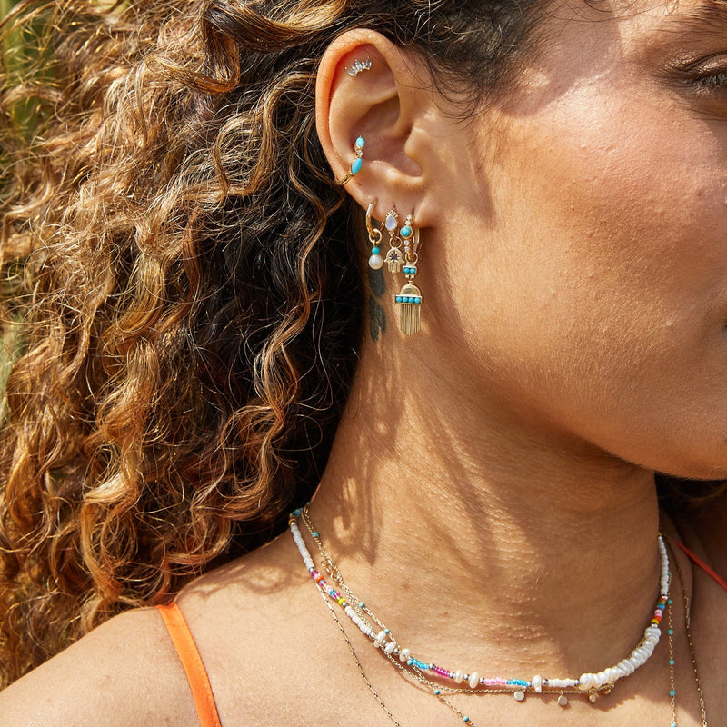 model showing ear stack in solid gold including the Copper Turquoise & White Sapphire Huggie Hoop Earring 9k Gold