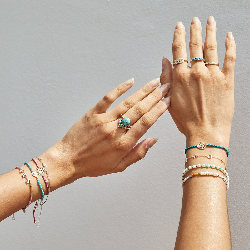 model hands wearing different jewellery pieces including the Semi-Precious Stone Hugging Ring 9k Gold