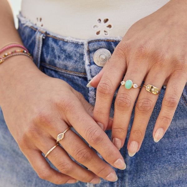 model wearing solid gold rings including the Chrysoprase & Moonstone Ring 9k Gold