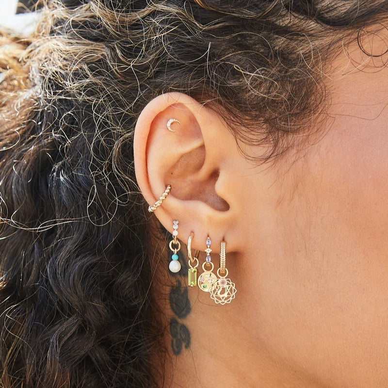 solid gold ear stack including the Peridot Baguette Hoop Earring 9k Gold