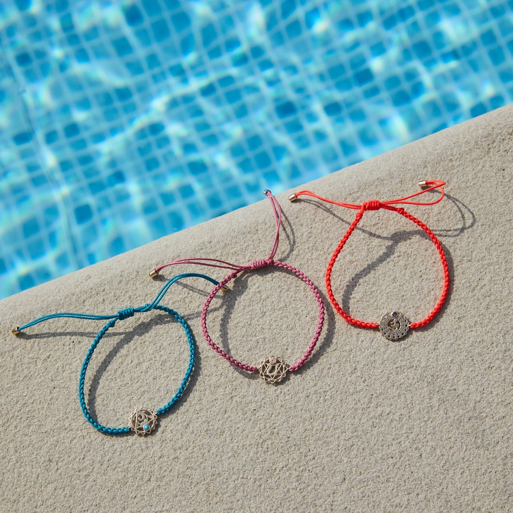 chakra bracelets by the pool including the Crown Chakra Bracelet 9k Gold