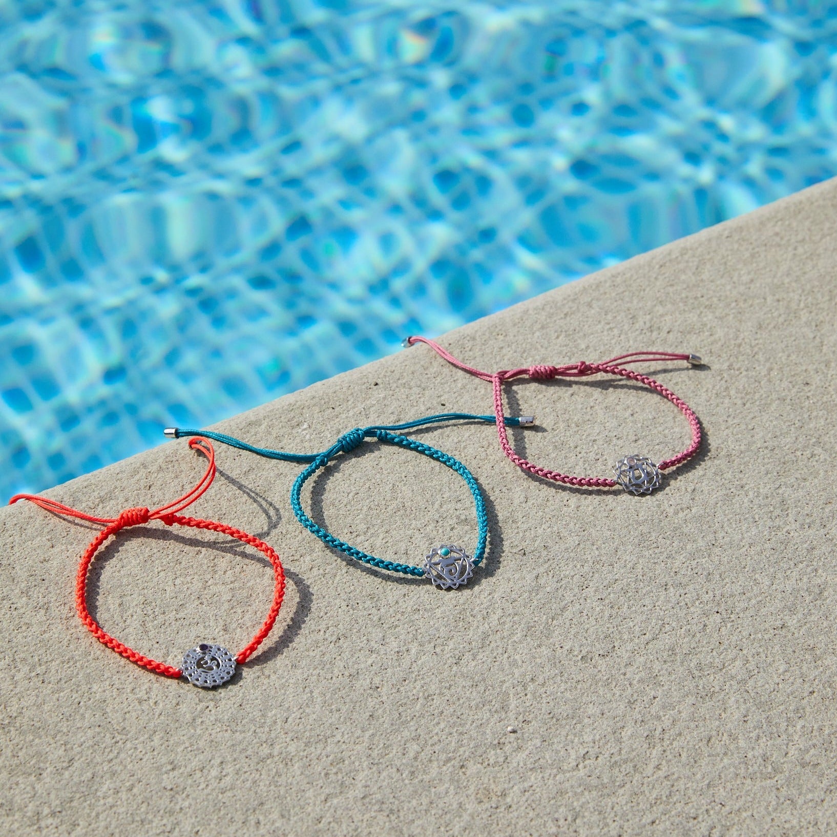 chakra bracelets by the pool including the Crown Chakra Bracelet sterling silver