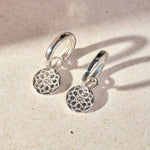 Zohreh Coin Earring Charm Sterling Silver with hoops on hard surface