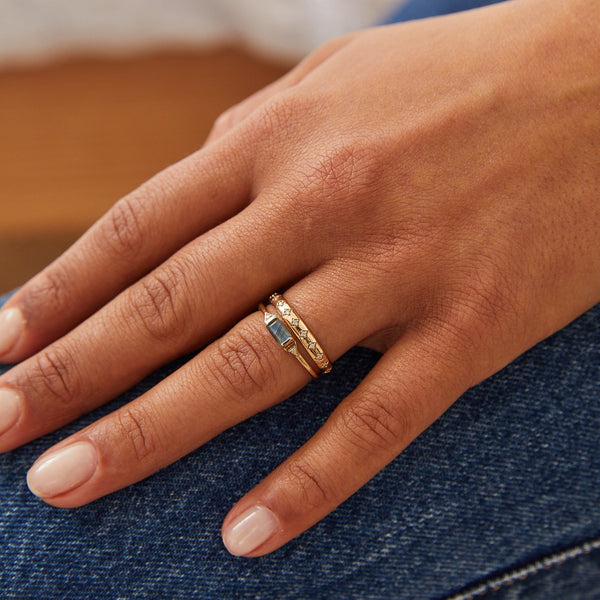 model wearing solid gold rings including the Diamond Star Engraved Ring 9k Gold