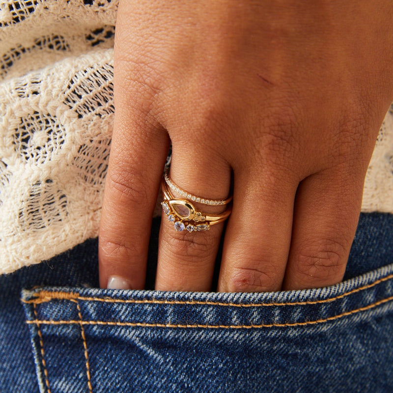 model wearing solid gold rings including the Diamond Half Eternity Ring 9k Gold