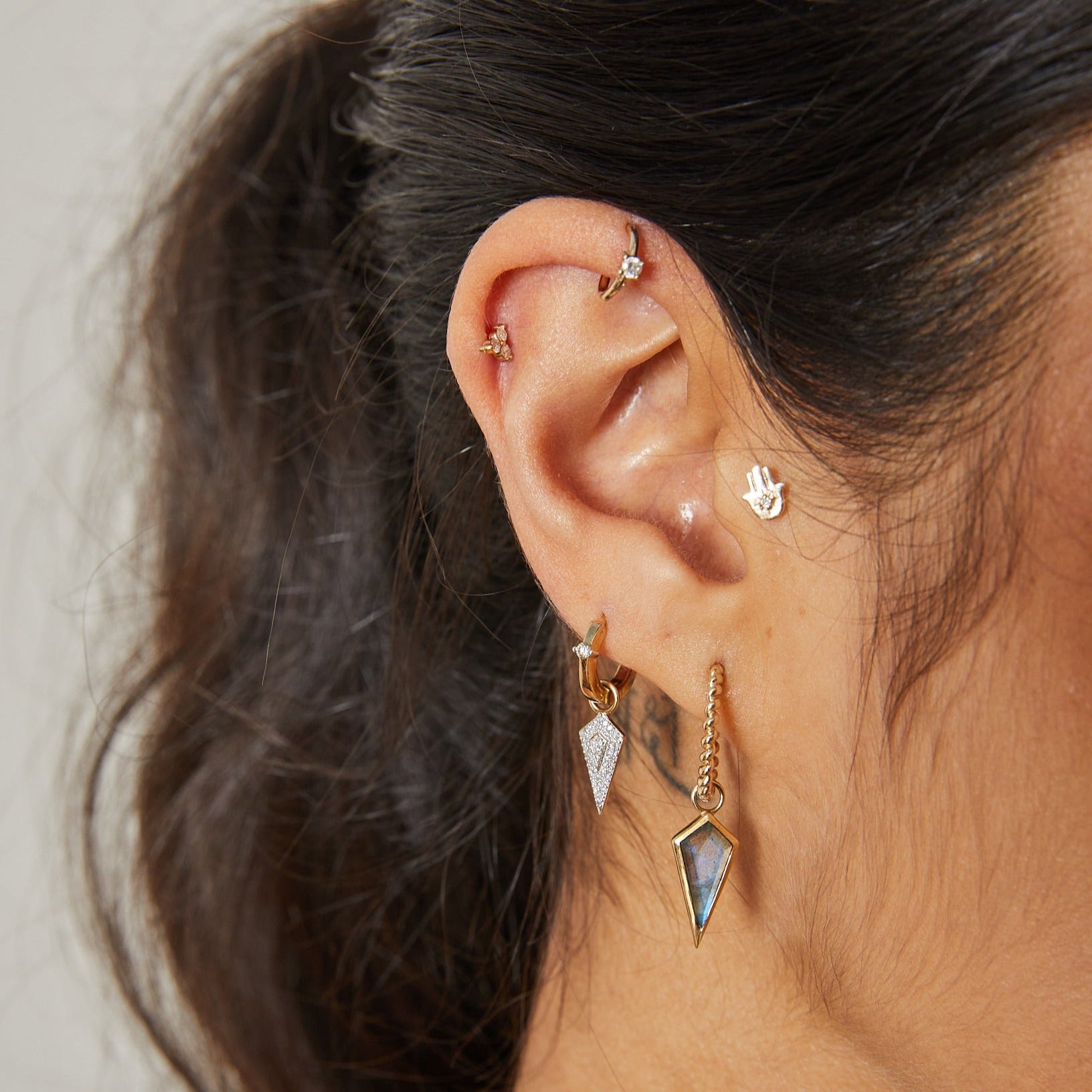 Solid gold ear stack including the twisted hoop and the Labradorite Rhombus Earring Charm 9k Gold