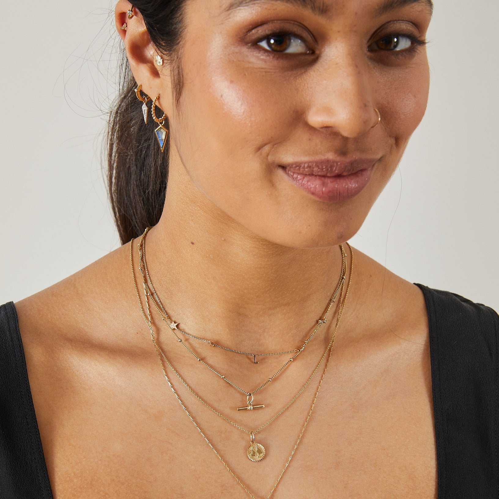 model wearing solid gold jewellery including the Labradorite Rhombus Earring Charm 9k Gold