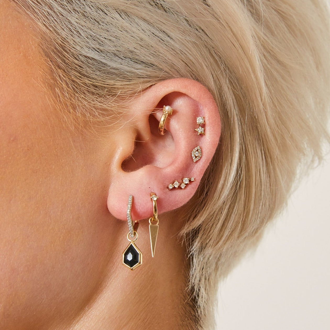 solid gold ear stack including the Spike Hoop Earrings 9k Gold