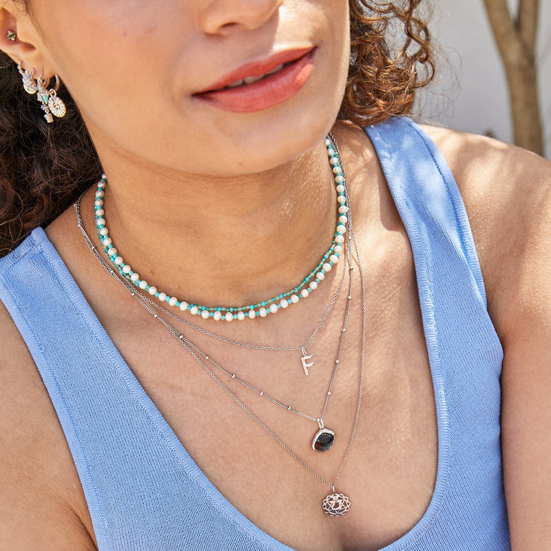 model wearing sterling silver layered necklaces including the Pearl & Turquoise Necklace Sterling Silver