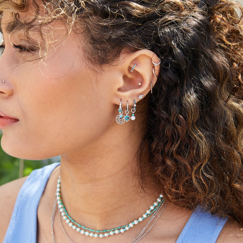 model wearing sterling silver and turquoise pieces including the Hammered Huggie Hoop Earring Sterling Silver