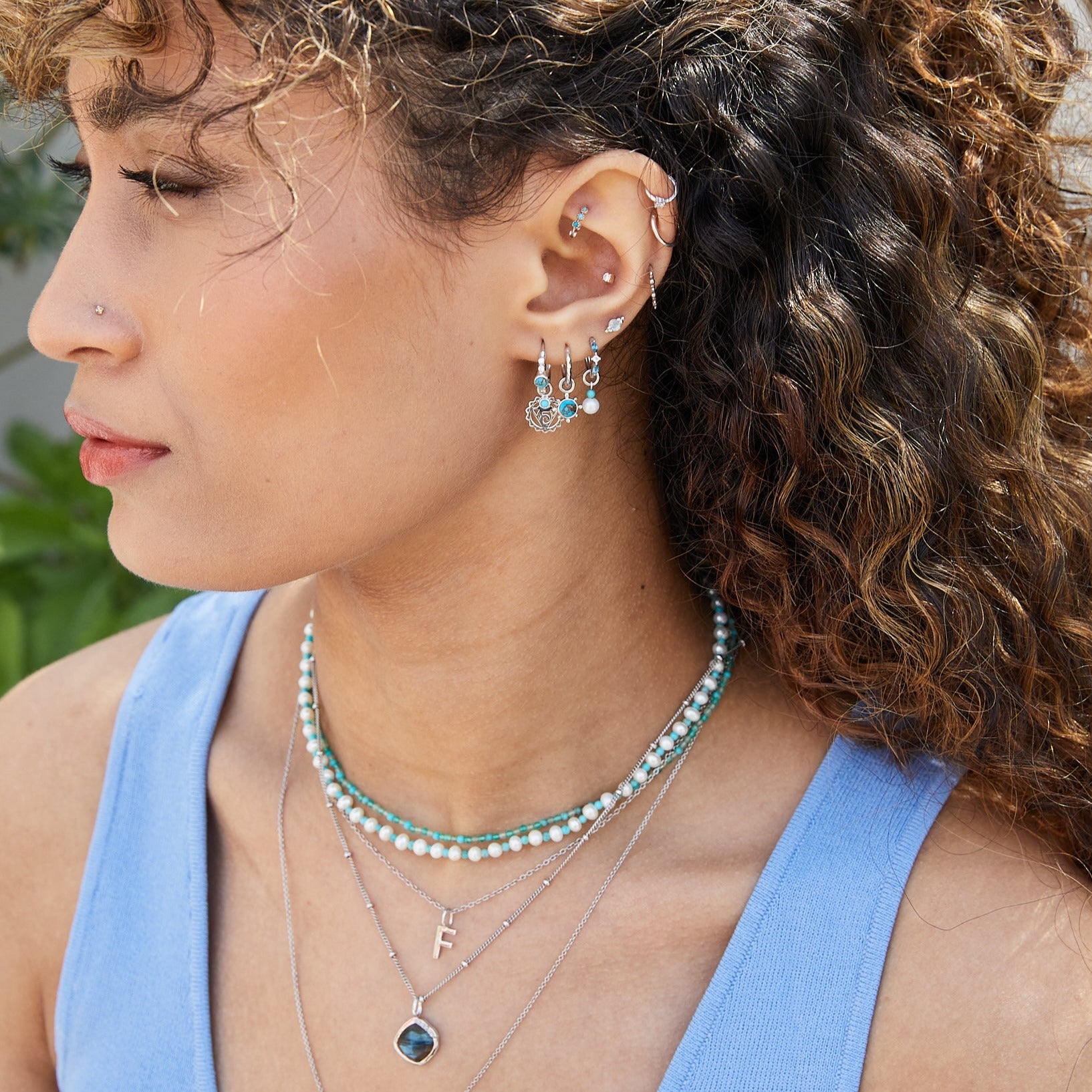 model wearing sterling silver and turquoise pieces including the Hammered Huggie Hoop Earring Sterling Silver