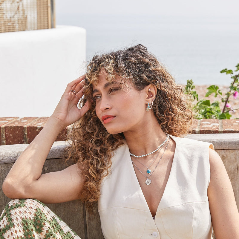 model wearing solid metal jewellery including the Pearl & Turquoise Necklace Sterling Silver