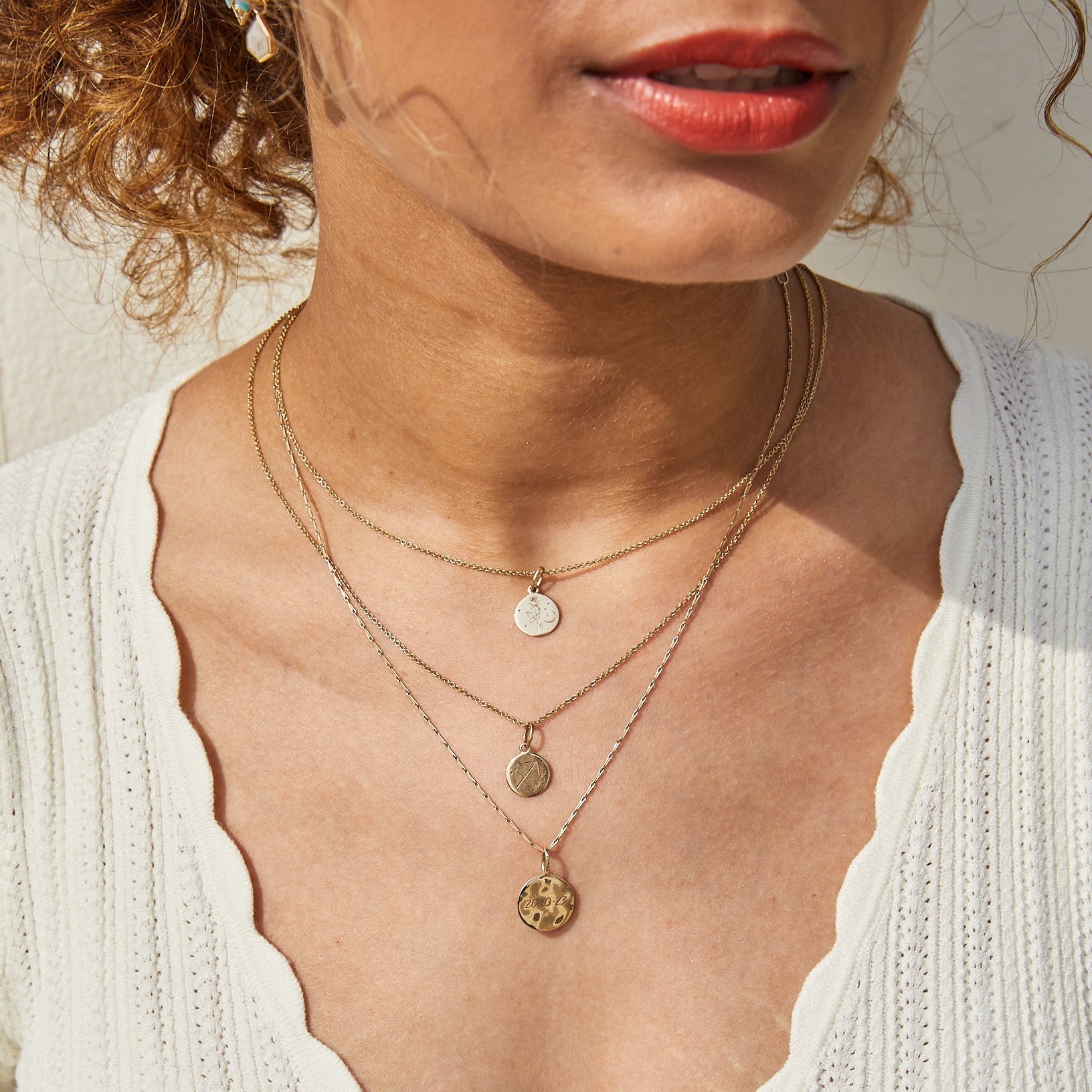 model wearing solid gold necklaces layered including the Organic Coin pendant 9k Gold