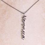 Name Pendant Sterling Silver on hard surface