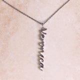 Name Pendant Sterling Silver on hard surface