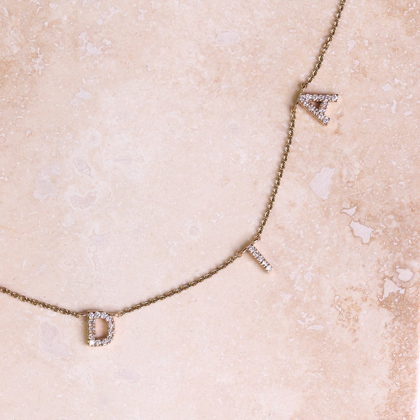 Personalised Diamond Initial Bracelet 9k Gold on hard surface