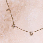 Personalised Diamond Initial Bracelet 9k Gold on hard surface
