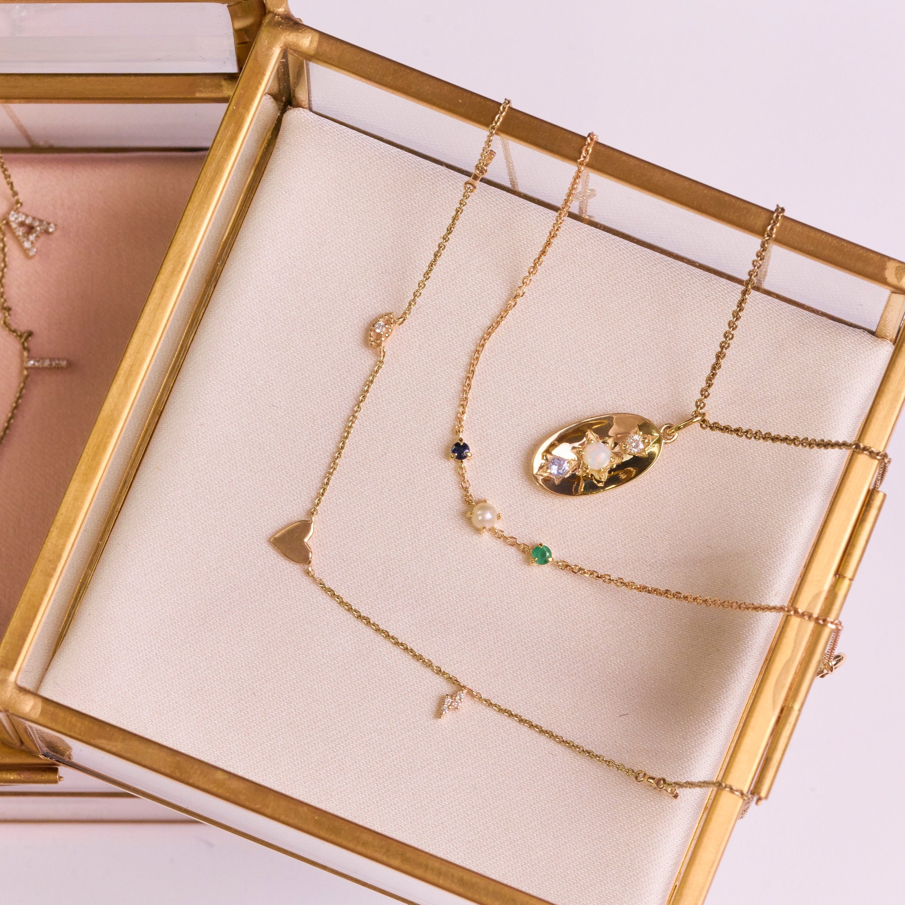 solid gold necklaces in jewellery box including the Personalised Initial Necklace 9k Gold