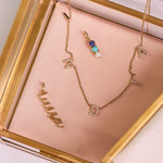 solid gold pieces in jewellery box including the Personalised Birthstone Trio Pendant 9k Gold