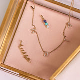 solid gold pieces in jewellery box including the Personalised Birthstone Trio Pendant 9k Gold