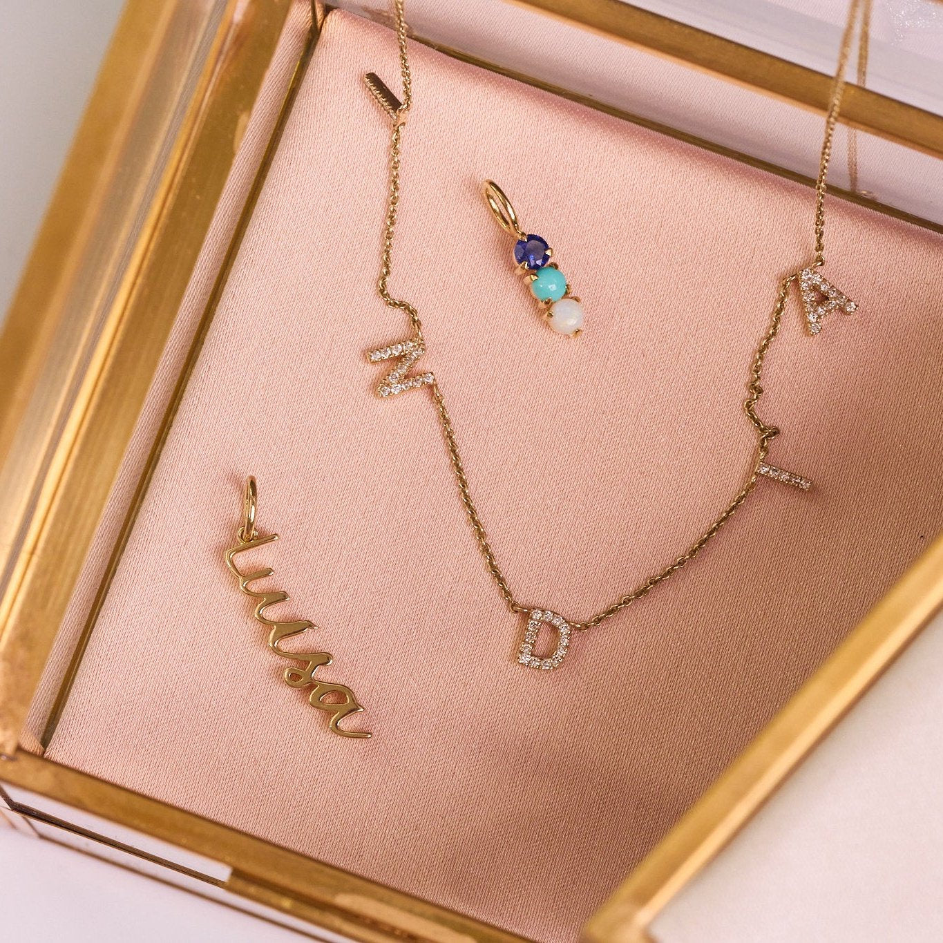 solid gold pieces in jewellery box including the Personalised Birthstone Trio Pendant 9k Gold