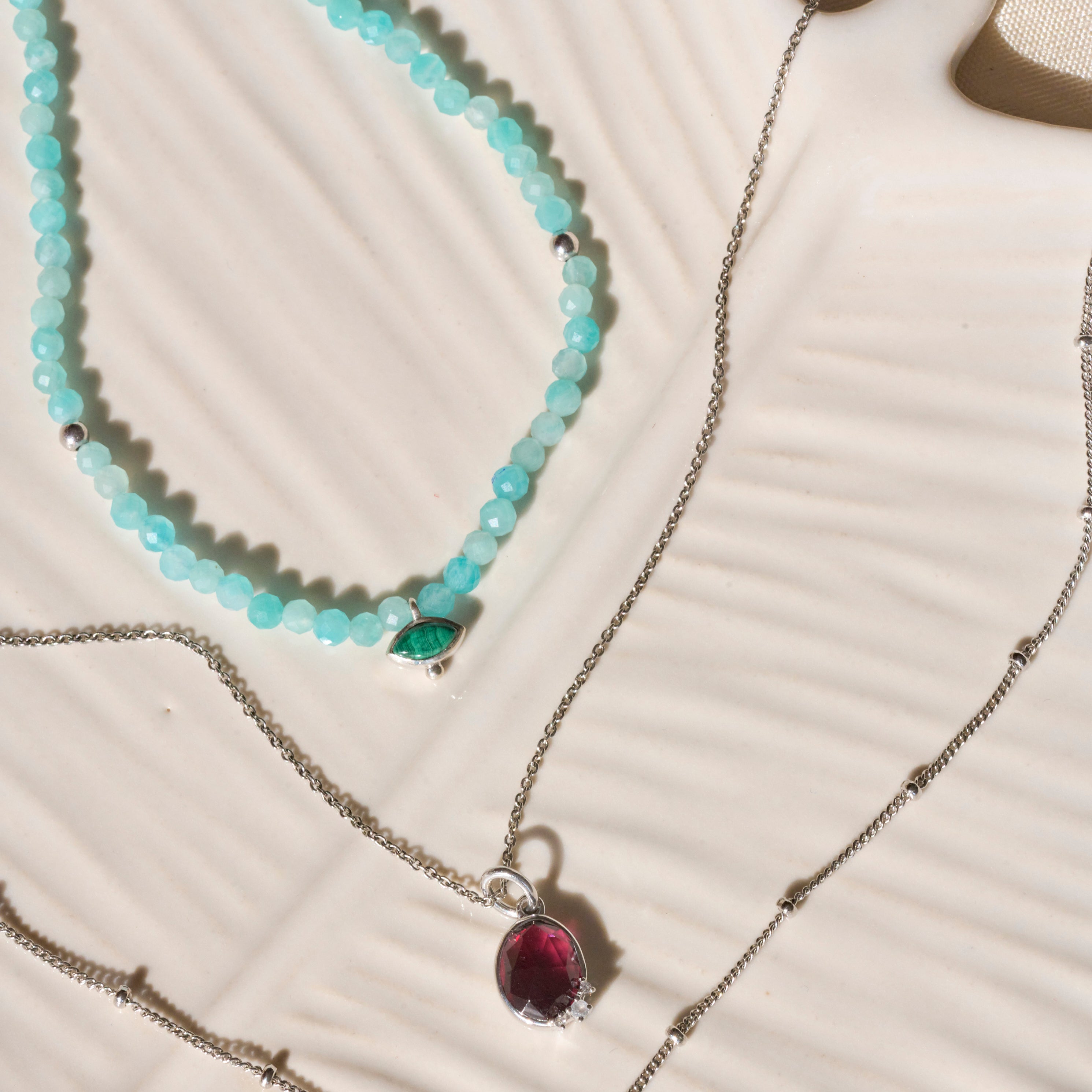 silver necklaces on ceramic dish