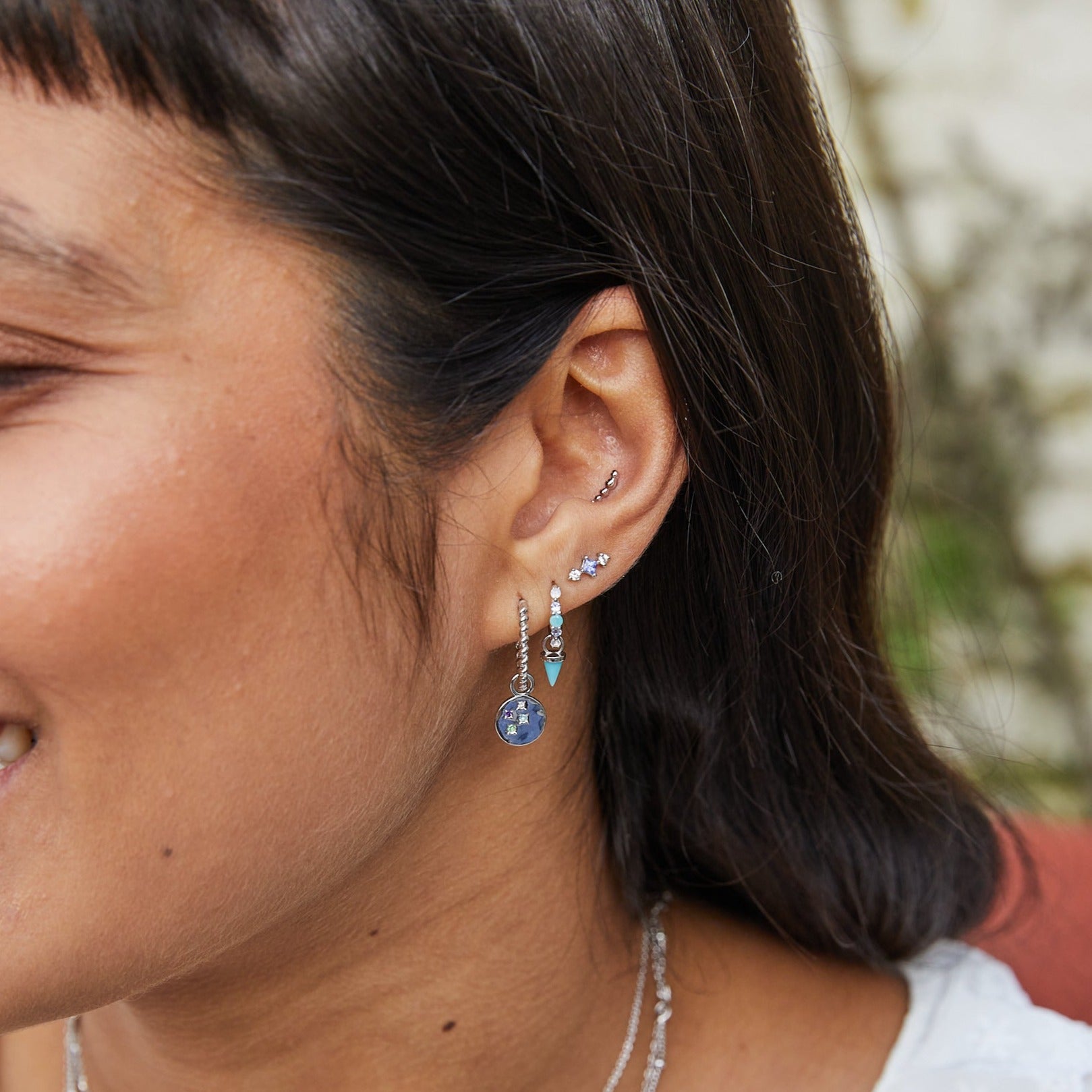 silver earrings on model