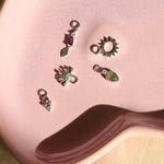 silver charms with stone on pink plate