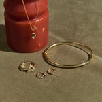 solid gold jewellery on green background and red object