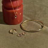 solid gold jewellery on green background and red object