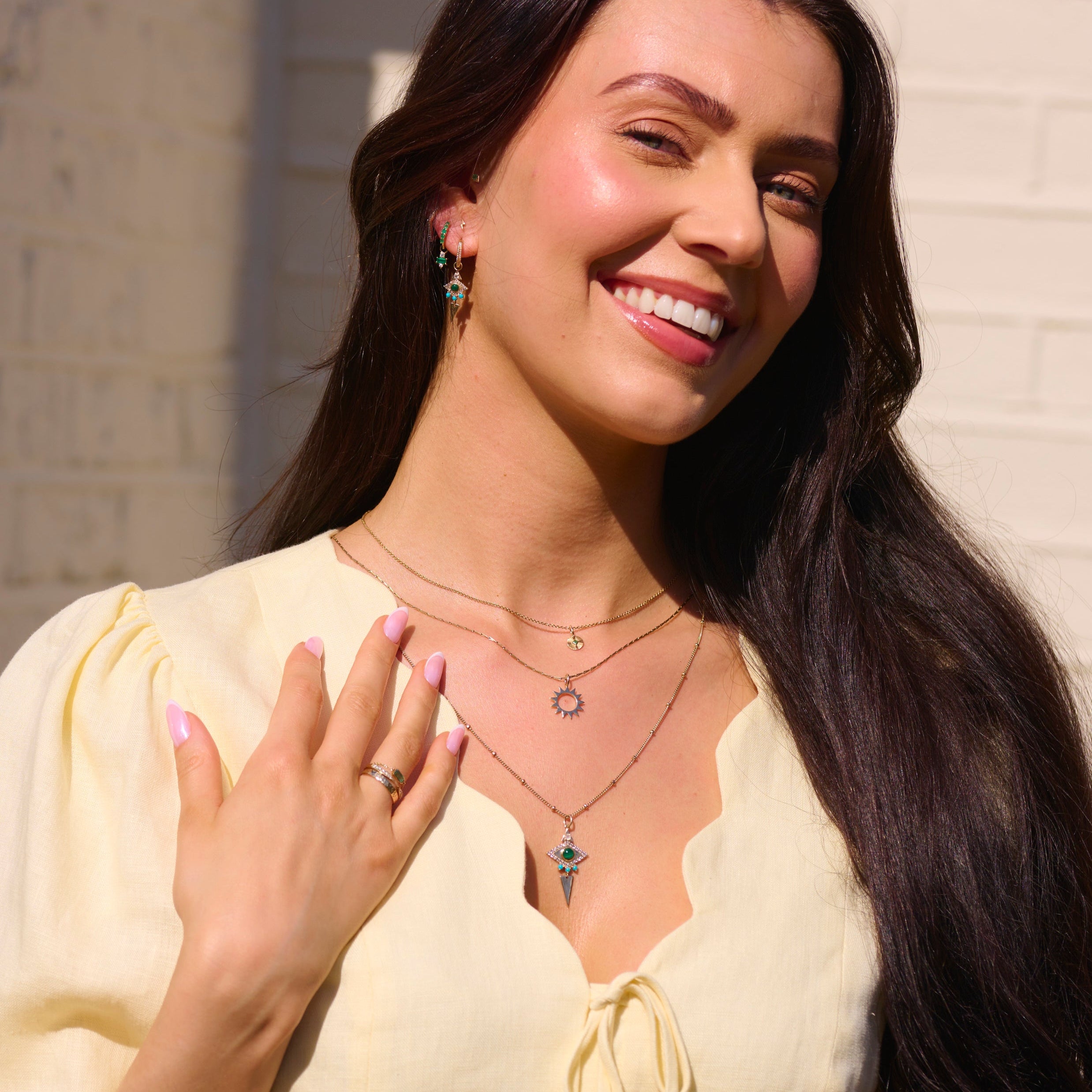 model wearing solid gold jewellery including the Limited Edition Malachite Eye Hoop Earrings 9k Gold