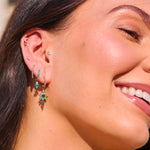 model wearing solid gold earrings including the Limited Edition Malachite Eye Hoop Earrings 9k Gold