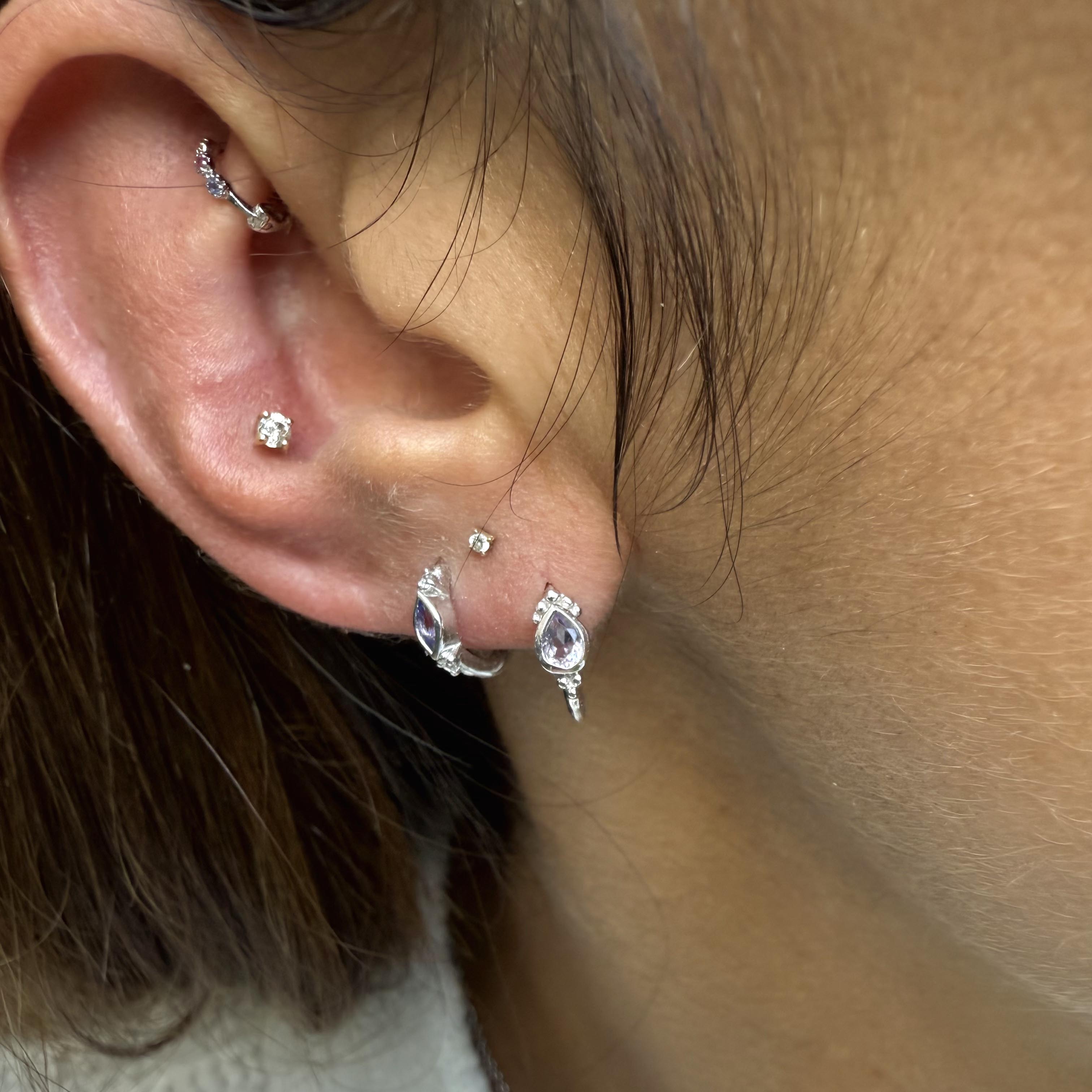 close up of two silver earrings 