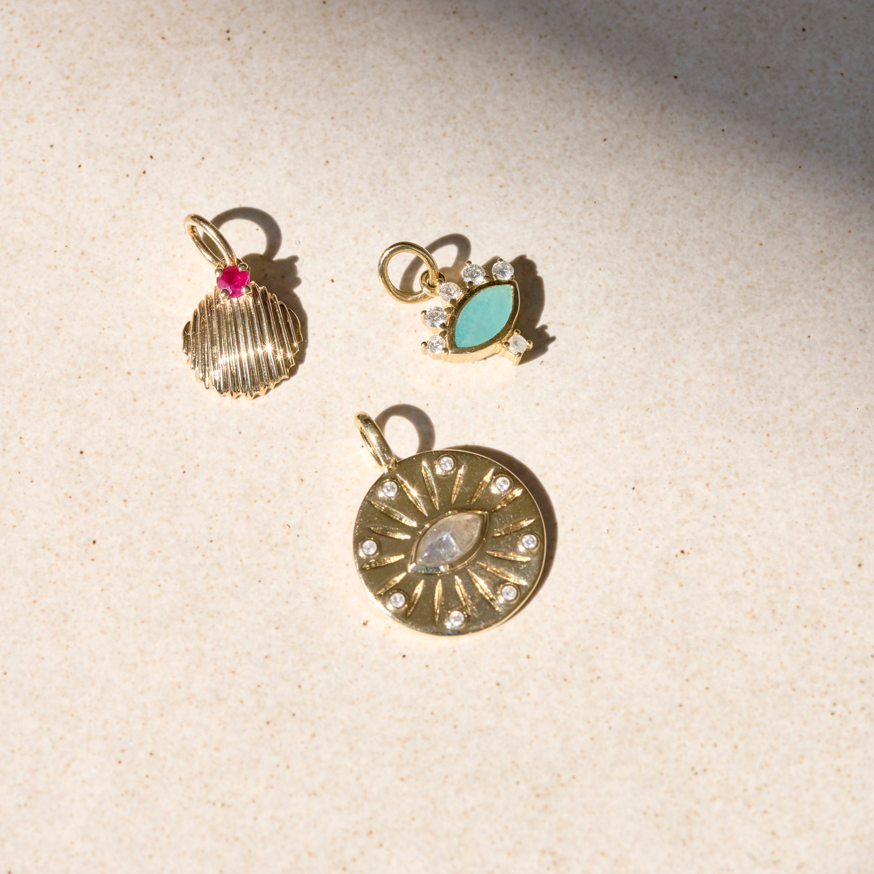 solid gold pendants on stone