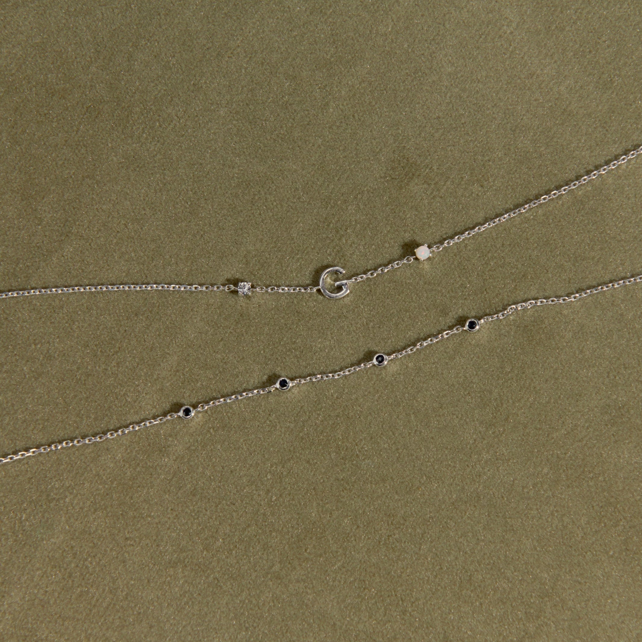 sterling silver bracelets on green background
