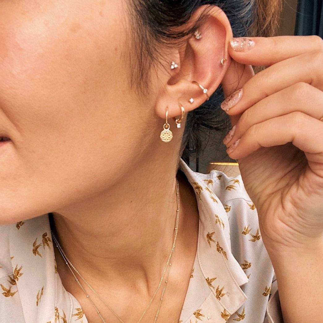 model wearing ear stack with diamond trilogy flat back earring gold on tragus