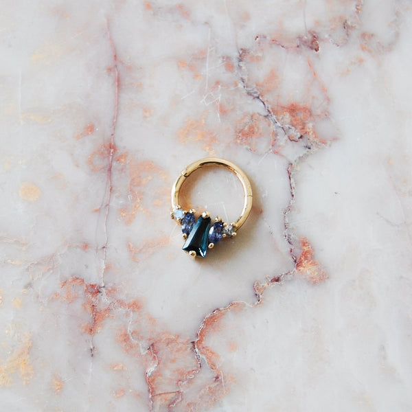 Singular London blue topaz daith earring, featuring moonstone, tanzanite & a 9 karat gold hoop