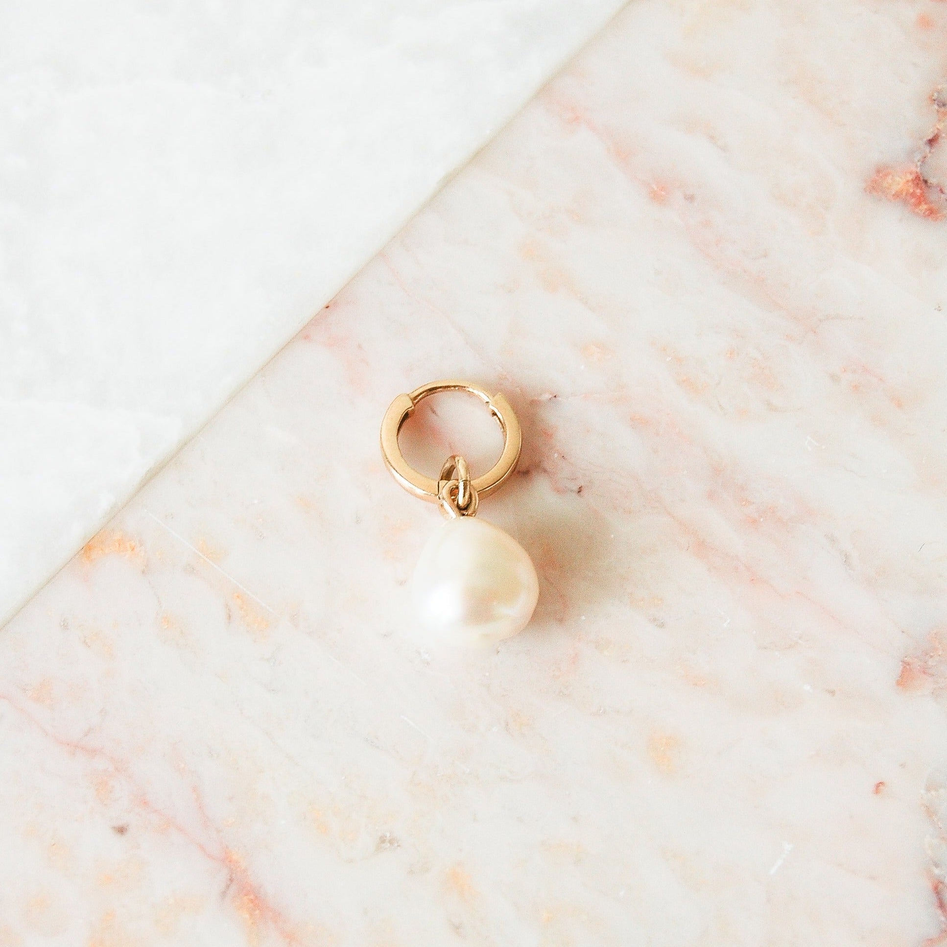 image of baroque pearl earring charm in 9k gold on huggie hoop