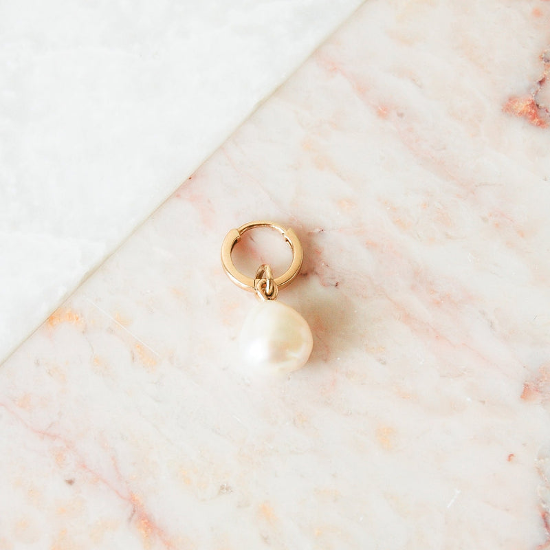 image of baroque pearl earring charm in 9k gold on huggie hoop