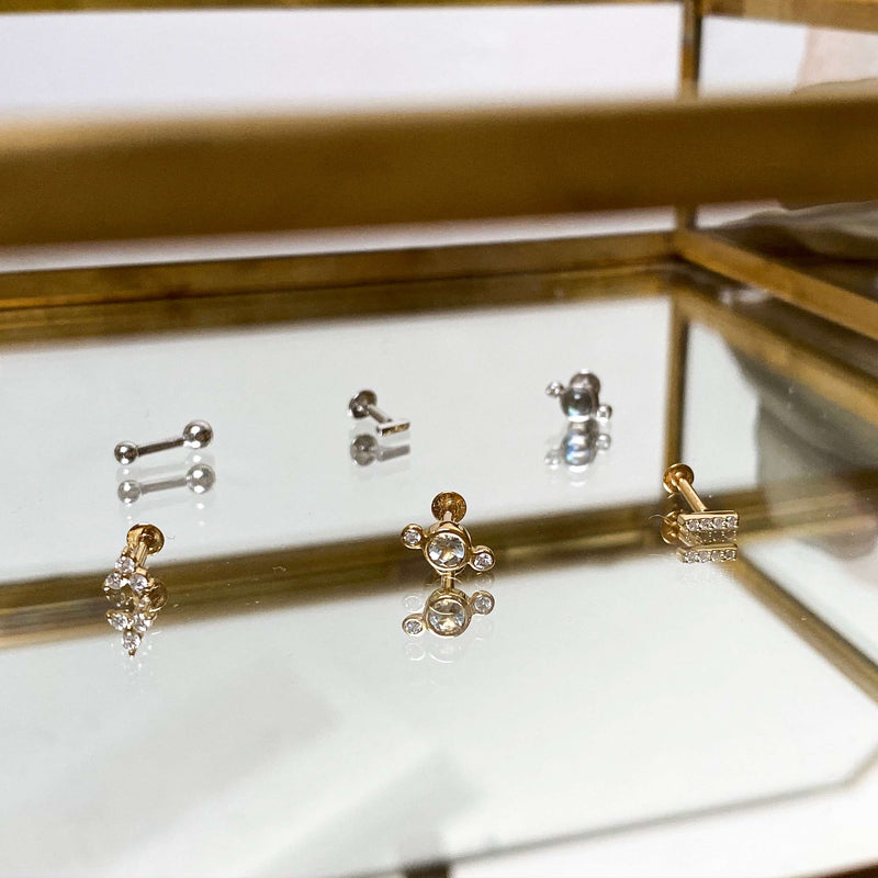 gold flat back earring display in mirror jewellery box including the diamond trilogy 