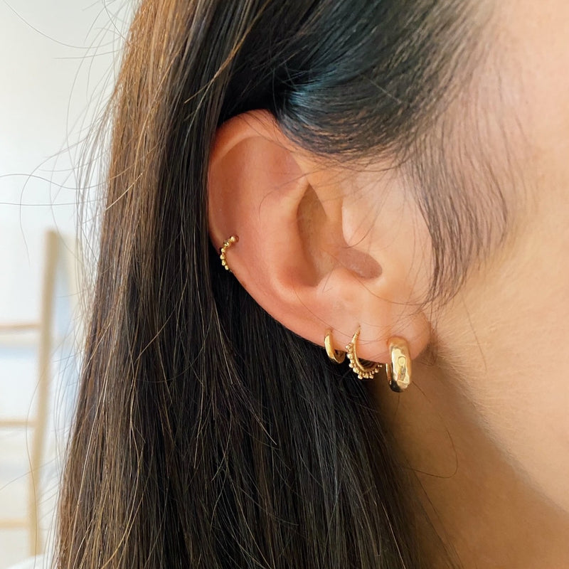 model wearing 9k gold ear stack including beaded hoop earring in 9k gold