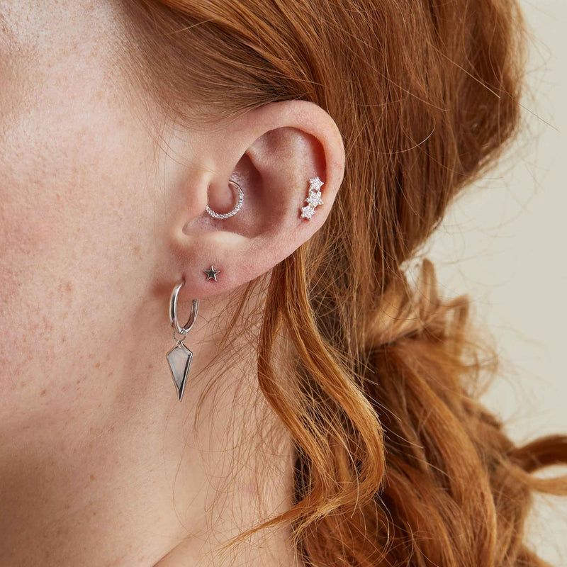 model wearing ear stack including diamond daith earring in sterling silver
